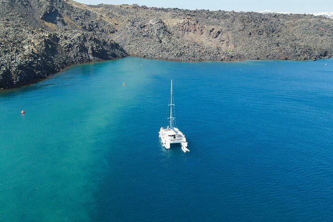 Best of Santorini Private Half-Day Catamaran Cruise with transfer and meal - Red Beach and the Akrotiri area: volcanic color, quick swim, and smart snorkeling