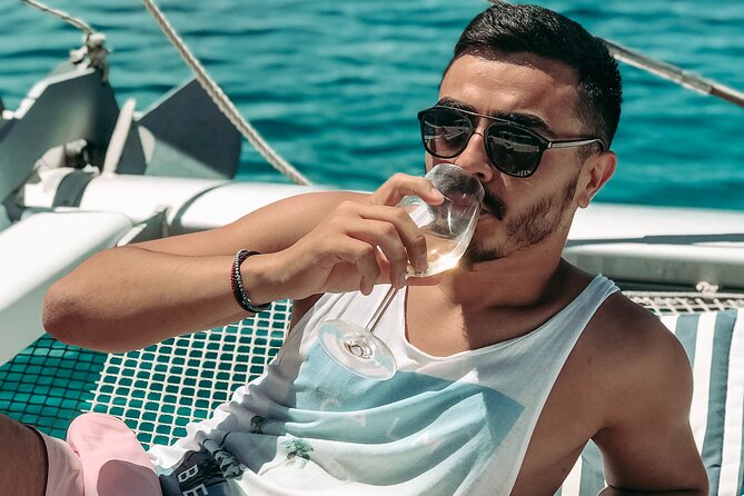 Chania: Afternoon Catamaran trip - Dinner, Drinks & Sunset - Agioi Theodoroi bay: swimming, snorkeling, SUP, fishing, and inflatable play