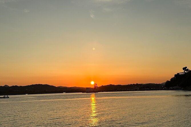 Corfu: Sunset Cruise on a Wooden Vessel with Cocktails & Bites - Mon Repos Palace, Greek and British layers along the shoreline