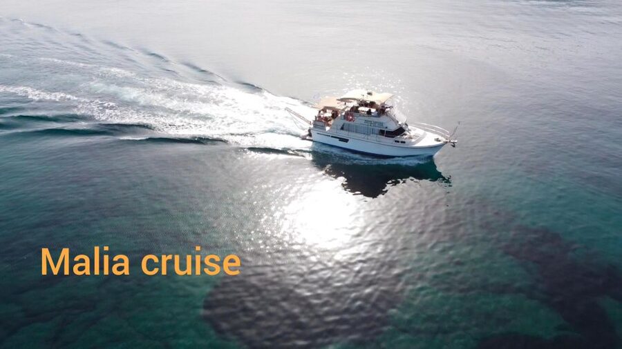 Crete: Snorkeling Boat Trip with Lunch and Transfer - Exploring Saint George Bay: sun time with rocky cliffs and green around you