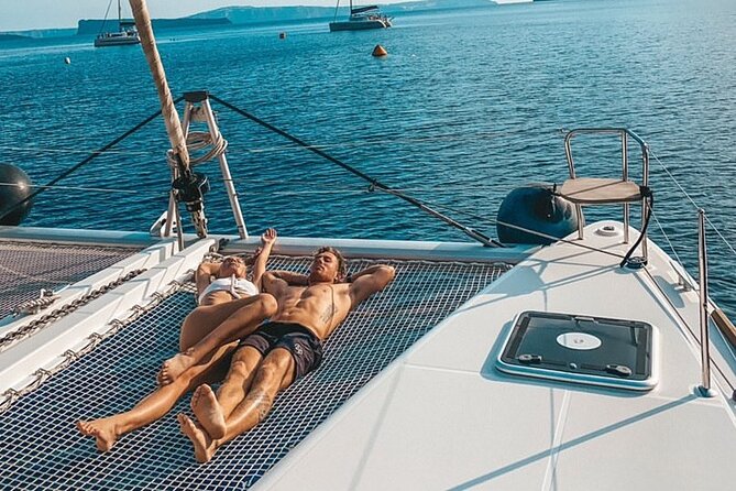 Half-Day Exclusive Catamaran Cruise in Santorini with Meal and Open Bar - Red Beach Stop: Photos, Cliffs, and a Quick Splash