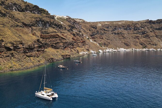 Luxury Santorini Sunset Cruise: Dinner, BBQ, Open Bar, Transfers - Red Beach, White Beach, Indian Rocks, and Akrotiri Lighthouse Pass