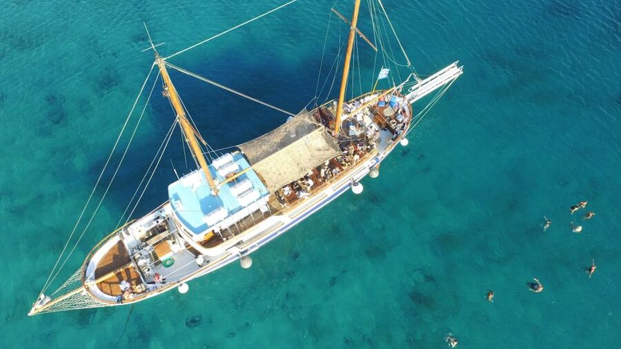 Mykonos: Sunset Party Boat Cruise with 1 Drink - DJ, dancing, and the Greek dance moment onboard