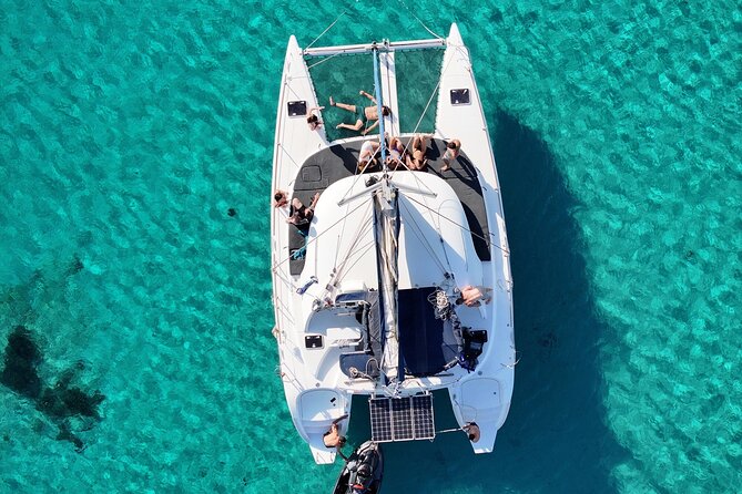 Private Mykonos Catamaran Day Cruise with Meals & Water Toys - Stop 3: Rineia, for clear water and anchored swim stops
