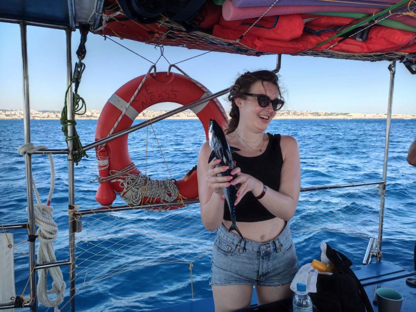 Rhodes: Fishing Trip, Snorkelling, BBQ, & Professional Guide - The onboard BBQ lunch: fish, Greek salad, and Rhodian oregano bread