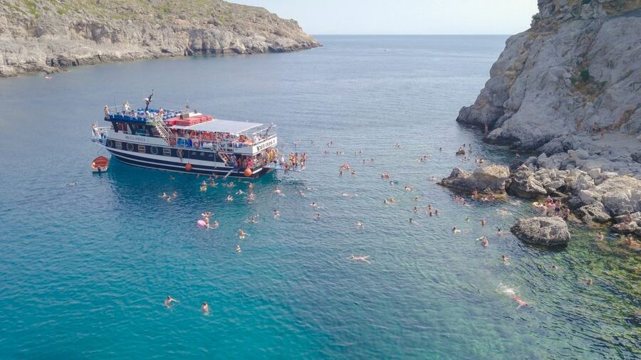 Rhodes Town: Scenic Cruise to Lindos with Swim Stops - Pickup and Mandraki Port check-in at the Church of the Annunciation