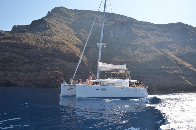 Santorini Caldera Gold Day Cruise with BBQ on board and Open Bar - Food, drinks, snorkeling gear, and the 7-language safety net