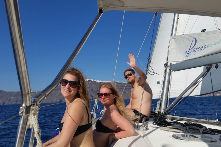 Santorini Caldera: Sunset Sailing Cruise with Meal - Inside the caldera: Indian Rock, the lighthouse, and sails up
