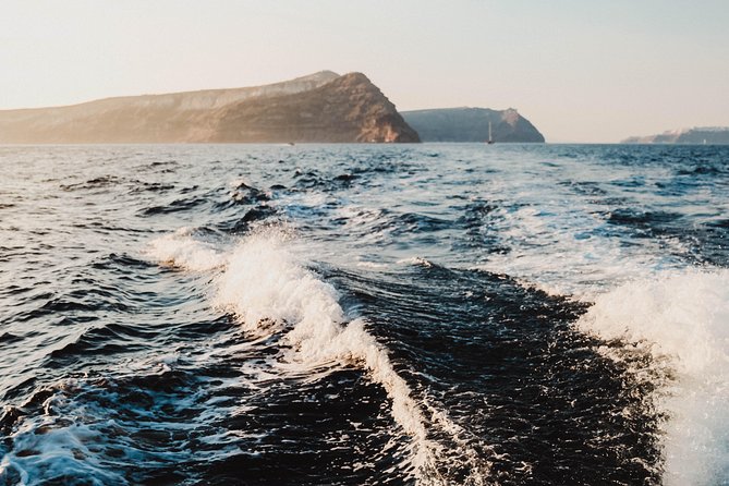 Santorini Caldera Sunset Traditional Cruise with Meal and Drinks - White Beach: a boat-only swim with crystal blue water