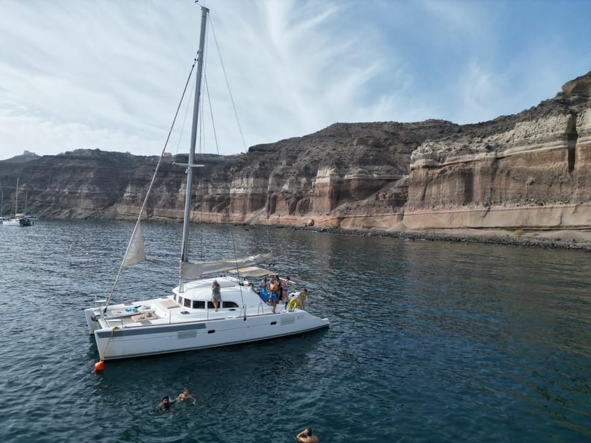 Santorini: Catamaran Cruise with Greek BBQ and Drinks - Akrotiri photo moments, Indian Rocks, and caldera sailing views