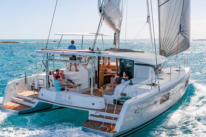 Santorini Catamaran Cruise with Greek Meal, Open-Bar and Sunset - Boarding the catamaran: room, restrooms, towels, and the crew