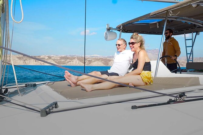 Santorini Catamaran Cruise with Greek Meal, Open-Bar and Sunset - The hot springs stop at Nea Kameni, warm water and sulfur reality