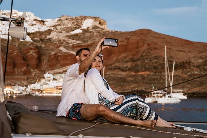 Santorini Catamaran Cruise with Greek Meal, Open-Bar and Sunset - Sunset from the water: the payoff you plan your day around