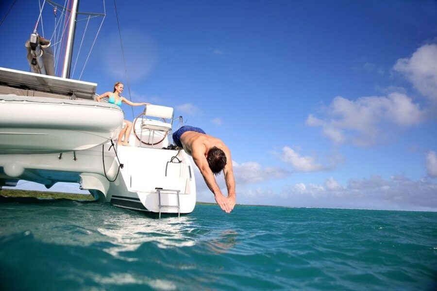 Santorini: Dream Catcher 5-hour Sailing Trip in the Caldera - Swim and snorkel in private bays, then on to the hot springs