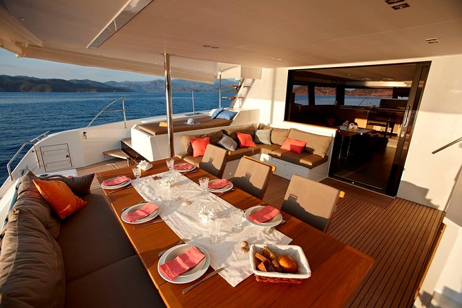 Santorini Luxury Catamaran Day Cruise with BBQ,drinks,transfer - Hot Springs swim and the ancient lighthouse from the sea