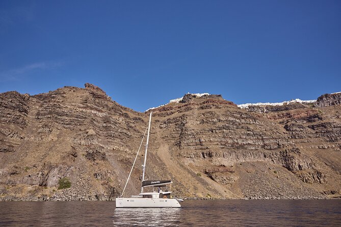 Santorini Oia: Luxury Sunset Cruise with Fresh Fish BBQ & Drinks - Thirassia Island: calm water, snorkel time, and a slower feel