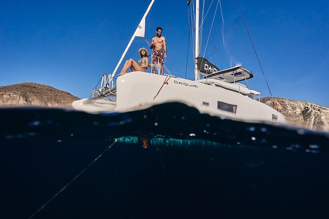 Santorini Oia: Luxury Sunset Cruise with Fresh Fish BBQ & Drinks - Mesa Pigadia beach: boat-only access and black sand clarity