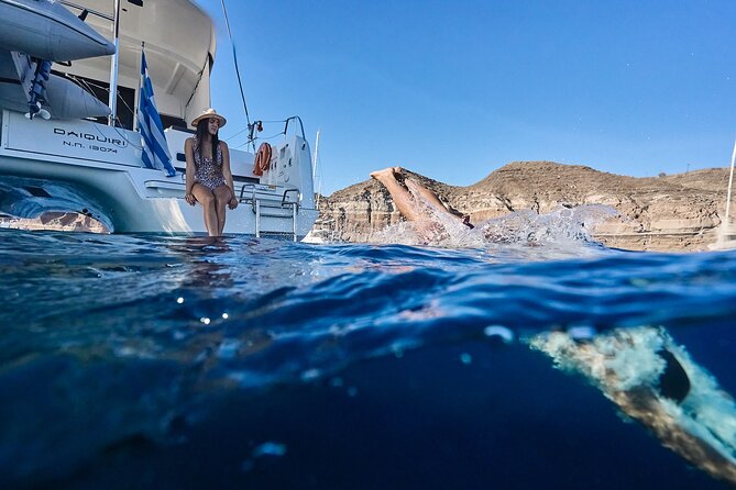 Santorini Oia: Luxury Sunset Cruise with Fresh Fish BBQ & Drinks - Red Beach and the color-changing coastline from the water